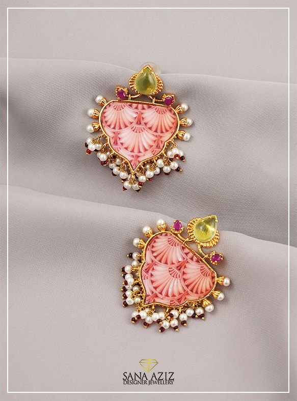 Detail view of the powder Pink shell Arabesque Earrings, from the Arabesque collection.