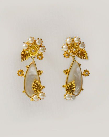 A pair of Lei floral cluster earrings with gold-plated blossoms above large mother-of-pearl drops edged with pearls.