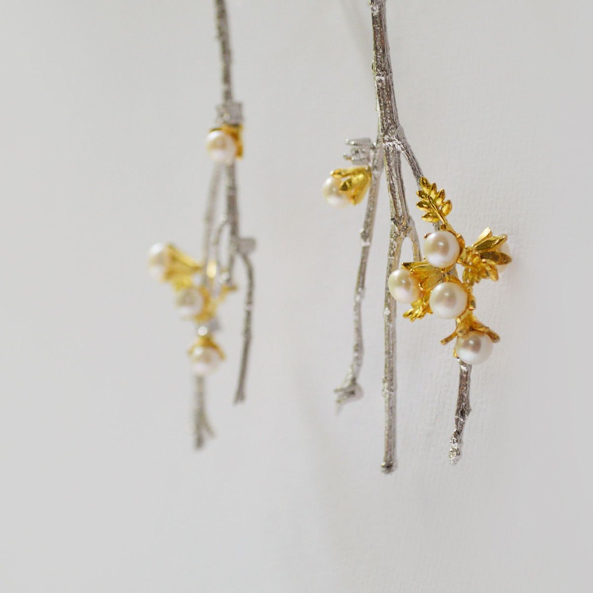 Detail view of the twig Earrings with Pearls, from the Lei collection.