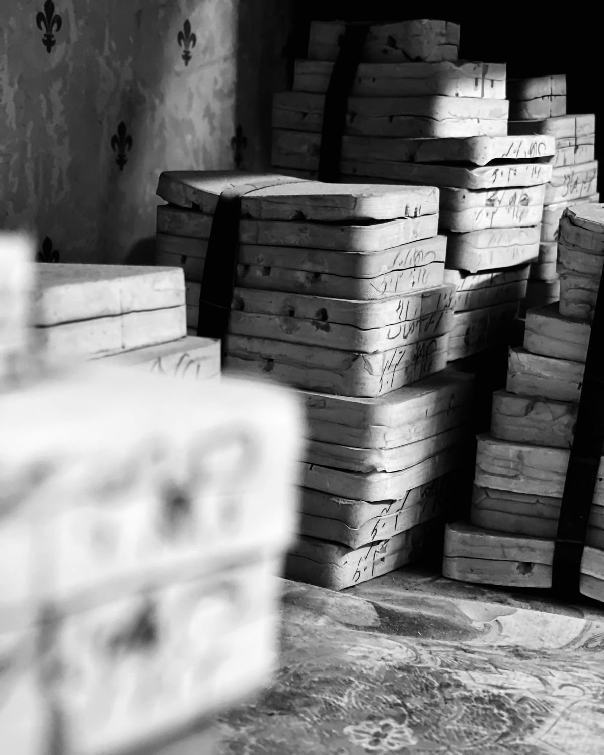 Stacks of numbered rubber casting moulds on the workbench.