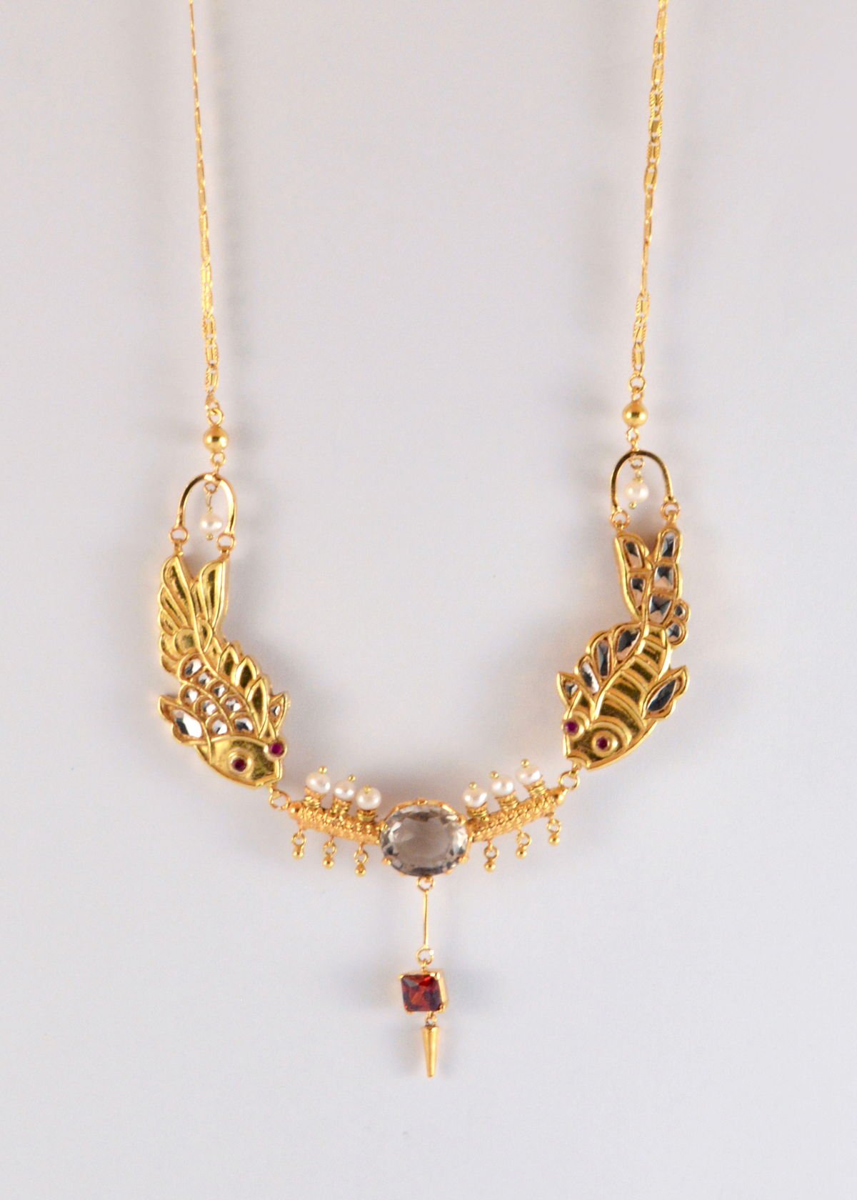 Fish pair necklace with smokey topaz and zircon, from the Safari collection.